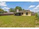 Fenced-in backyard with an enclosed patio area and a glimpse of the home's exterior features mature landscaping at 1720 Fruitridge St, Brandon, FL 33510
