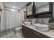 Modern bathroom featuring double sinks, large mirrors, and a tiled shower with curtain at 1720 Fruitridge St, Brandon, FL 33510