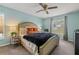 Bright bedroom featuring a king sized bed, ceiling fan, and neutral colored walls at 1720 Fruitridge St, Brandon, FL 33510