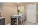 A charming dining area featuring a wooden table set for two near a window and a white door at 1720 Fruitridge St, Brandon, FL 33510