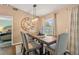 Elegant dining area with a long wooden table, comfortable seating, and modern lighting fixture at 1720 Fruitridge St, Brandon, FL 33510