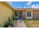 The home's front door is accompanied by trimmed bushes and a walkway at 1720 Fruitridge St, Brandon, FL 33510