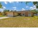 Inviting single-story residence featuring a well-maintained lawn and a convenient two-car garage at 1720 Fruitridge St, Brandon, FL 33510