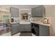 Modern kitchen features gray cabinets, stainless steel appliances, and an open floor plan at 1720 Fruitridge St, Brandon, FL 33510