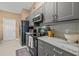 Modern kitchen featuring gray cabinets, stainless steel appliances, and a marble countertop at 1720 Fruitridge St, Brandon, FL 33510