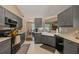 Stylish kitchen boasts gray cabinetry, stainless steel appliances, and an open view to the dining area at 1720 Fruitridge St, Brandon, FL 33510