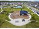 Aerial view of a community playground, park, and pool, highlighting the recreational amenities for residents at 17589 Cruiser Bnd, Land O Lakes, FL 34638