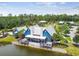 Scenic aerial view of a clubhouse by the lake, showcasing the surrounding greenery and outdoor amenities at 17589 Cruiser Bnd, Land O Lakes, FL 34638