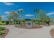 Welcoming entrance to the bark yard featuring a spacious play area for pets surrounded by lush greenery and trees at 17589 Cruiser Bnd, Land O Lakes, FL 34638