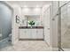 Elegant bathroom with a double vanity, granite countertops, a tiled floor, and a glass-enclosed shower at 17589 Cruiser Bnd, Land O Lakes, FL 34638