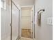 Modern bathroom with a glass-enclosed shower and access to the walk-in closet at 17589 Cruiser Bnd, Land O Lakes, FL 34638
