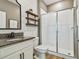Stylish bathroom featuring modern fixtures, granite countertops, and a tiled shower for a luxurious experience at 17589 Cruiser Bnd, Land O Lakes, FL 34638