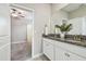 Bathroom with double vanity featuring granite countertops and access to bedroom at 17589 Cruiser Bnd, Land O Lakes, FL 34638