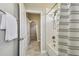 Bathroom view features white tile, shower, and access to bedroom space at 17589 Cruiser Bnd, Land O Lakes, FL 34638
