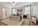 Spacious bedroom with hardwood floors, a ceiling fan, and natural light creates a serene retreat at 17589 Cruiser Bnd, Land O Lakes, FL 34638
