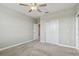 Bedroom with neutral carpet, ceiling fan, and double-door closet for ample storage at 17589 Cruiser Bnd, Land O Lakes, FL 34638