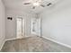 Inviting carpeted bedroom with open doorways, neutral walls, and a ceiling fan at 17589 Cruiser Bnd, Land O Lakes, FL 34638