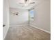 Neutral carpeted bedroom featuring a ceiling fan, a window, and decorated with floral accents at 17589 Cruiser Bnd, Land O Lakes, FL 34638