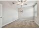 Cozy carpeted bedroom featuring a ceiling fan, a window with blinds, and floral wall decor at 17589 Cruiser Bnd, Land O Lakes, FL 34638