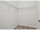 Walk-in closet with wire shelving and neutral carpeting for organized storage at 17589 Cruiser Bnd, Land O Lakes, FL 34638