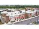 Aerial view of commercial area with retail shops, including a lash studio and a bar, with ample parking spaces at 17589 Cruiser Bnd, Land O Lakes, FL 34638