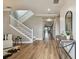 Light and airy entryway with hardwood floors, white staircase and modern decor at 17589 Cruiser Bnd, Land O Lakes, FL 34638