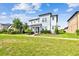 Two story home on a manicured lawn with some landscaping surrounded by green grass at 17589 Cruiser Bnd, Land O Lakes, FL 34638