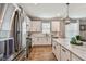 Beautiful kitchen boasts stainless steel appliances, white cabinets, and marble countertops with modern fixtures at 17589 Cruiser Bnd, Land O Lakes, FL 34638