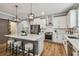 Modern kitchen features stainless steel appliances, white cabinets, marble island, and pendant lighting at 17589 Cruiser Bnd, Land O Lakes, FL 34638