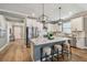 Beautiful kitchen features a marble island, stainless steel appliances, white cabinets, and modern bar stool seating at 17589 Cruiser Bnd, Land O Lakes, FL 34638