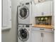 Convenient laundry area with stacked washer/dryer and practical built-in storage cabinets at 17589 Cruiser Bnd, Land O Lakes, FL 34638
