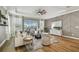 Comfortable living room with views of the pool, stylish decor, and hardwood flooring at 17589 Cruiser Bnd, Land O Lakes, FL 34638