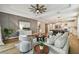 Open floor plan with a stylish living room, hardwood floors, and a modern ceiling fan at 17589 Cruiser Bnd, Land O Lakes, FL 34638