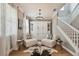 Living room features hardwood floors, neutral palette, white staircase, and built in shelving at 17589 Cruiser Bnd, Land O Lakes, FL 34638