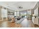 Bright living room with hardwood floors, a stylish ceiling fan, and views of the pool at 17589 Cruiser Bnd, Land O Lakes, FL 34638