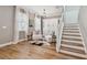 Bright living room with hardwood floors, modern decor, and stairs at 17589 Cruiser Bnd, Land O Lakes, FL 34638