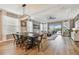 Open-concept living and dining area with wood floors, stylish lighting, and pool view at 17589 Cruiser Bnd, Land O Lakes, FL 34638