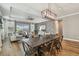 Spacious living area with stylish decor, wood floors, and a contemporary dining set at 17589 Cruiser Bnd, Land O Lakes, FL 34638