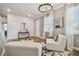 Well-lit living room with a hardwood floor, chic lighting, and white furniture creates a stylish, inviting space at 17589 Cruiser Bnd, Land O Lakes, FL 34638