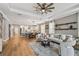 Open living space with hardwood floors, kitchen, dining area, and stylish modern decor at 17589 Cruiser Bnd, Land O Lakes, FL 34638