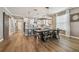 Open floor plan with dining table, kitchen, and hardwood floors, filled with natural light at 17589 Cruiser Bnd, Land O Lakes, FL 34638