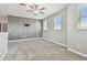 Bright loft area with a stylish accent wall, plush carpeting, and a ceiling fan at 17589 Cruiser Bnd, Land O Lakes, FL 34638