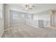 Spacious loft area showcasing plush carpeting, ceiling fan, and neutral-toned walls at 17589 Cruiser Bnd, Land O Lakes, FL 34638