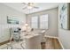Bright office with a glass desk, stylish chairs, and wainscoting offers a modern workspace at 17589 Cruiser Bnd, Land O Lakes, FL 34638