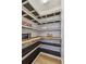 Spacious pantry with custom wood shelving, microwave, and decorative ceiling design at 17589 Cruiser Bnd, Land O Lakes, FL 34638