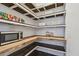 Spacious pantry with custom wood shelving, microwave, and decorative ceiling design at 17589 Cruiser Bnd, Land O Lakes, FL 34638