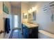 Modern bathroom featuring a marble vanity, stainless steel light fixtures, and beachy decor at 18518 Bittern Ave, Lutz, FL 33558