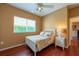 Cozy bedroom with a window, closet, ceiling fan, and hardwood floors at 18518 Bittern Ave, Lutz, FL 33558