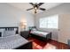 Comfortable bedroom with two twin beds, a ceiling fan, and bright, natural lighting through a window at 18518 Bittern Ave, Lutz, FL 33558