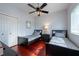 Comfortable bedroom with two twin beds, a ceiling fan, and bright, natural lighting through a window at 18518 Bittern Ave, Lutz, FL 33558